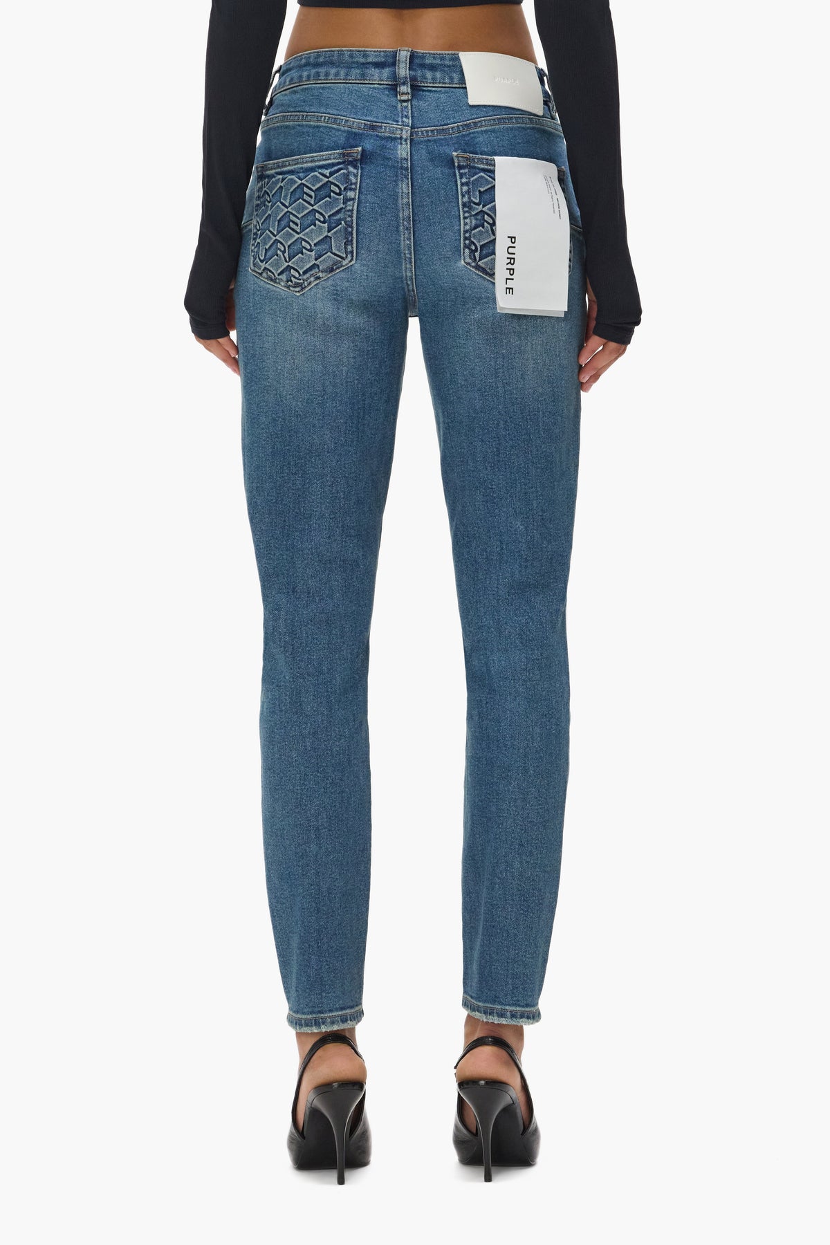Skinny Monogram denim jeans in sizes 24 to 34 with embossed monogram on back pockets.