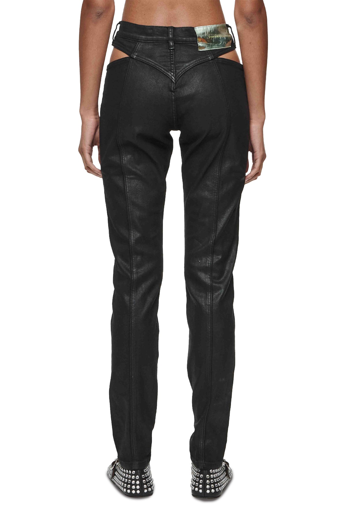 Skinny Cut Out Coated Denim in Black with cut out details at hip and front zipper fly.
