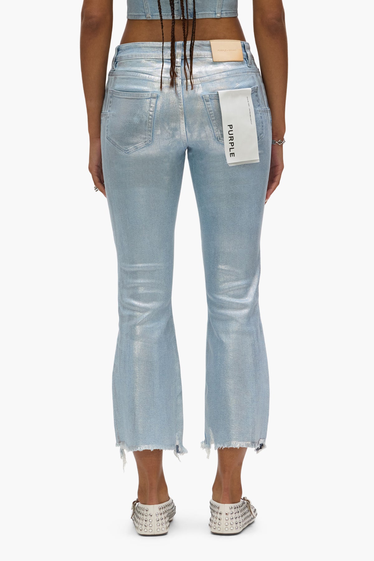 Ankle bootcut denim featuring all-over silver foil and frayed hem in sizes 24 to 34.