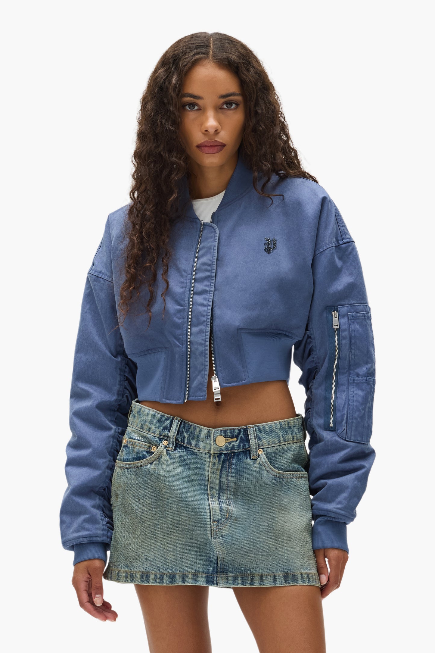 Cropped Bomber Jacket in light cotton twill with branded patch, available in various sizes.