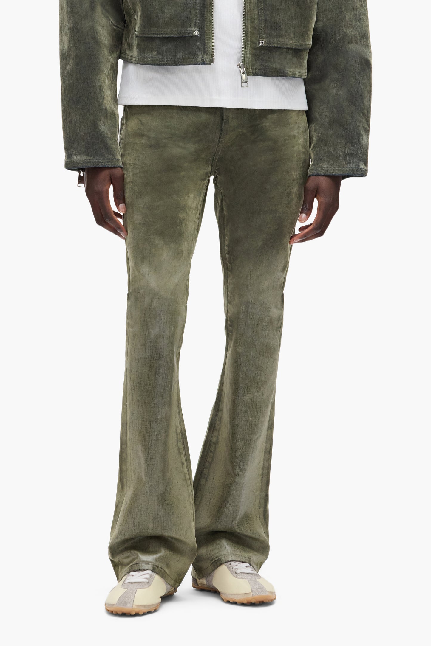 Flock Dipped denim with flared leg in green, low rise, slim fit, and 5 pocket styling.