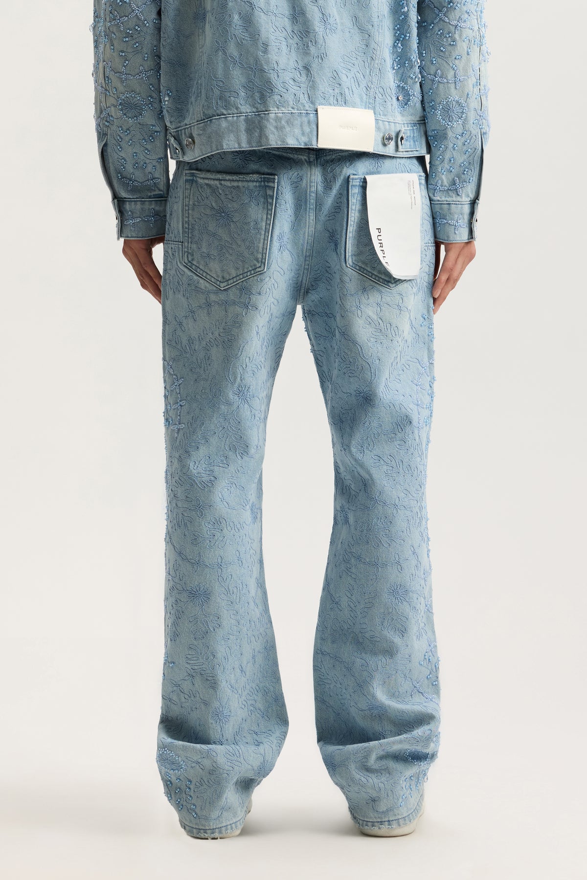 P026 Embellished mid-rise bootcut denim with signature Purple hangtag and branded leather patch.