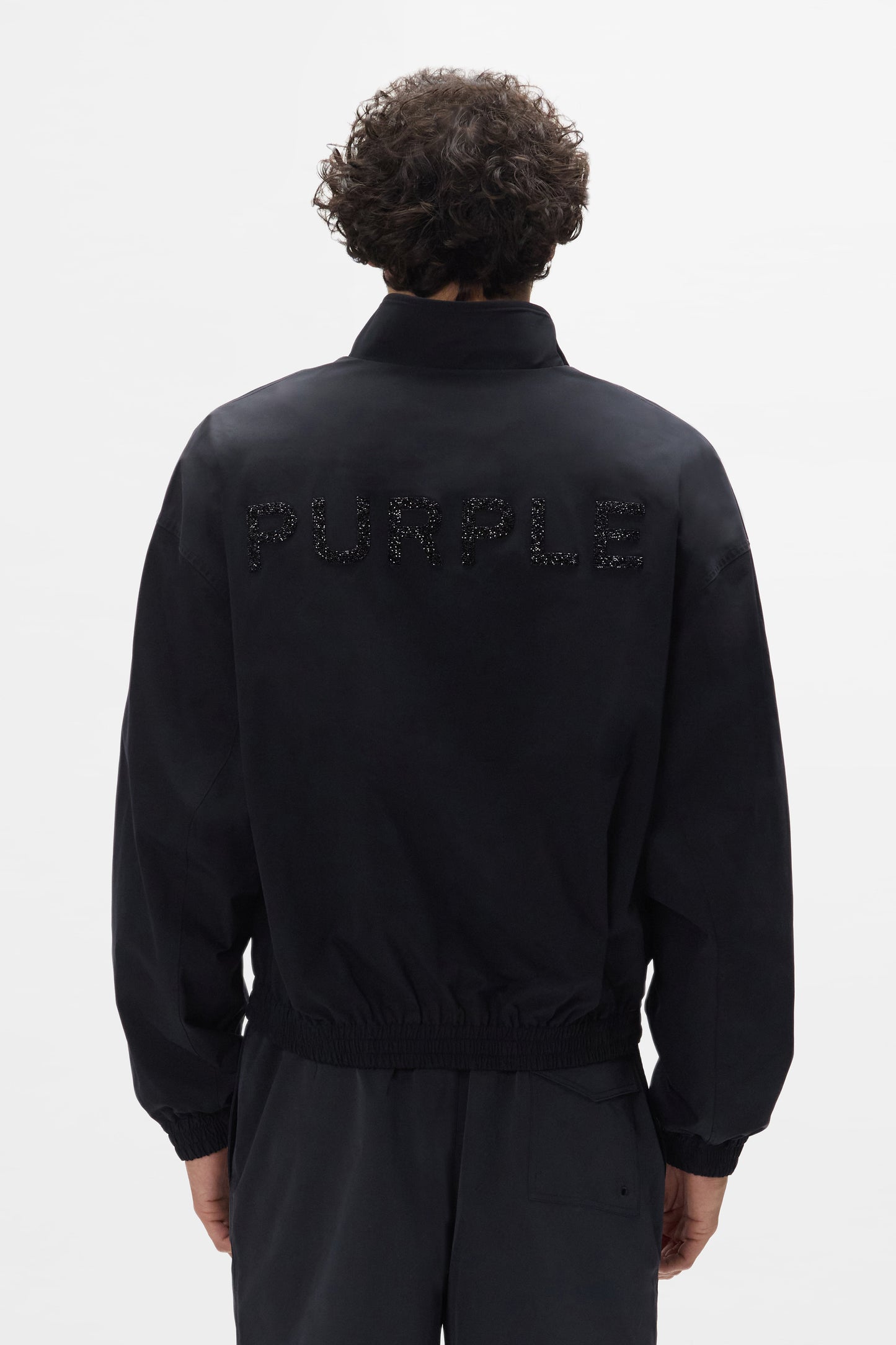 Crystal Wordmark Track Jacket with front zipper in relaxed fit, made of water-repellent polyester.
