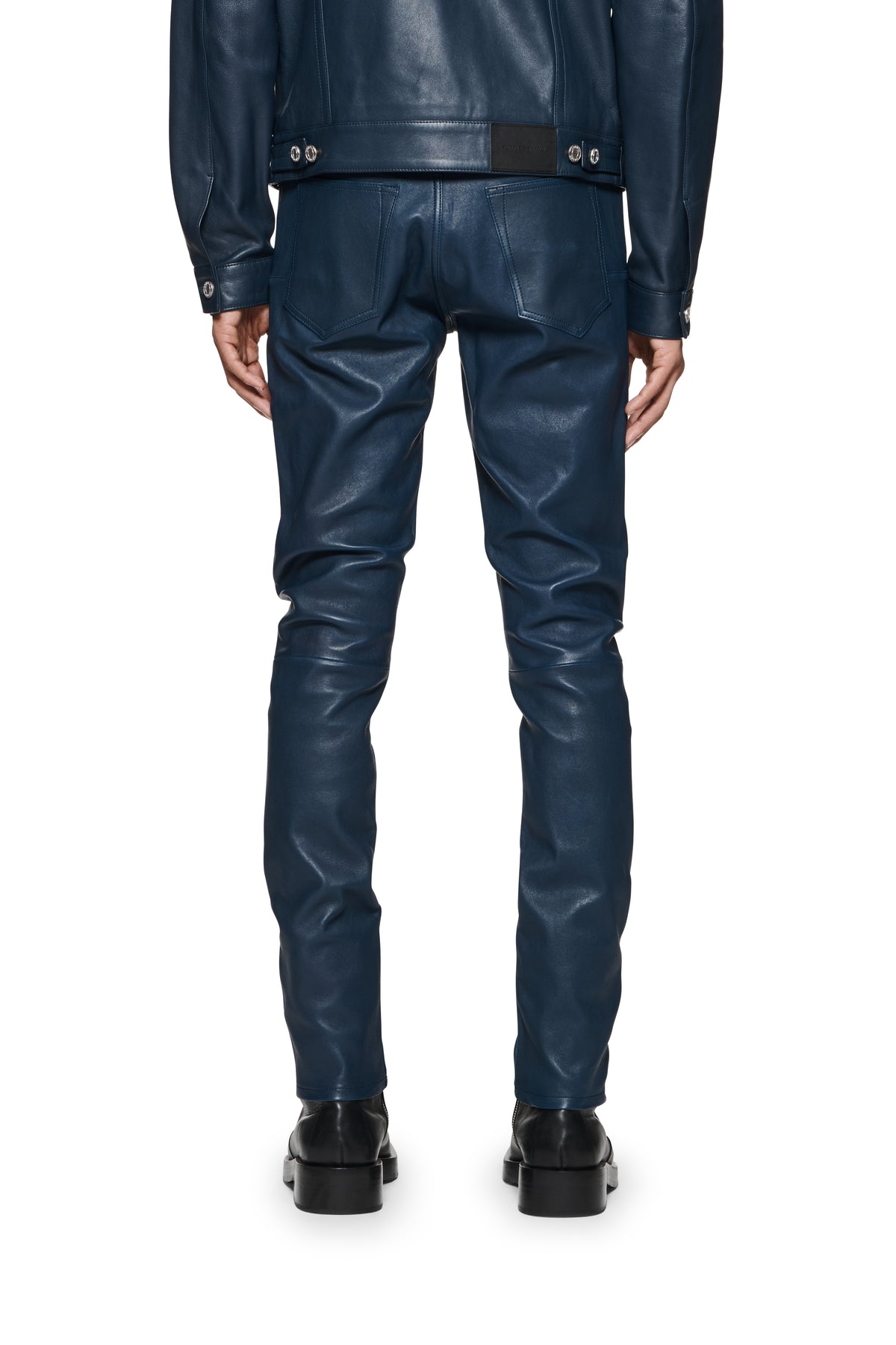 Low rise skinny stretch leather pants in blue with five pocket styling and reinforced belt loops.