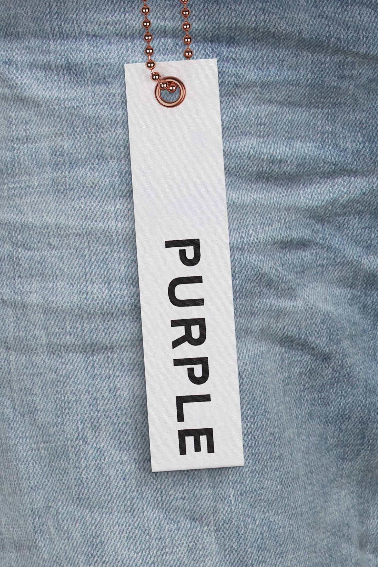 P002 mid rise slim jeans in light indigo with blowout detailing and five pocket styling.