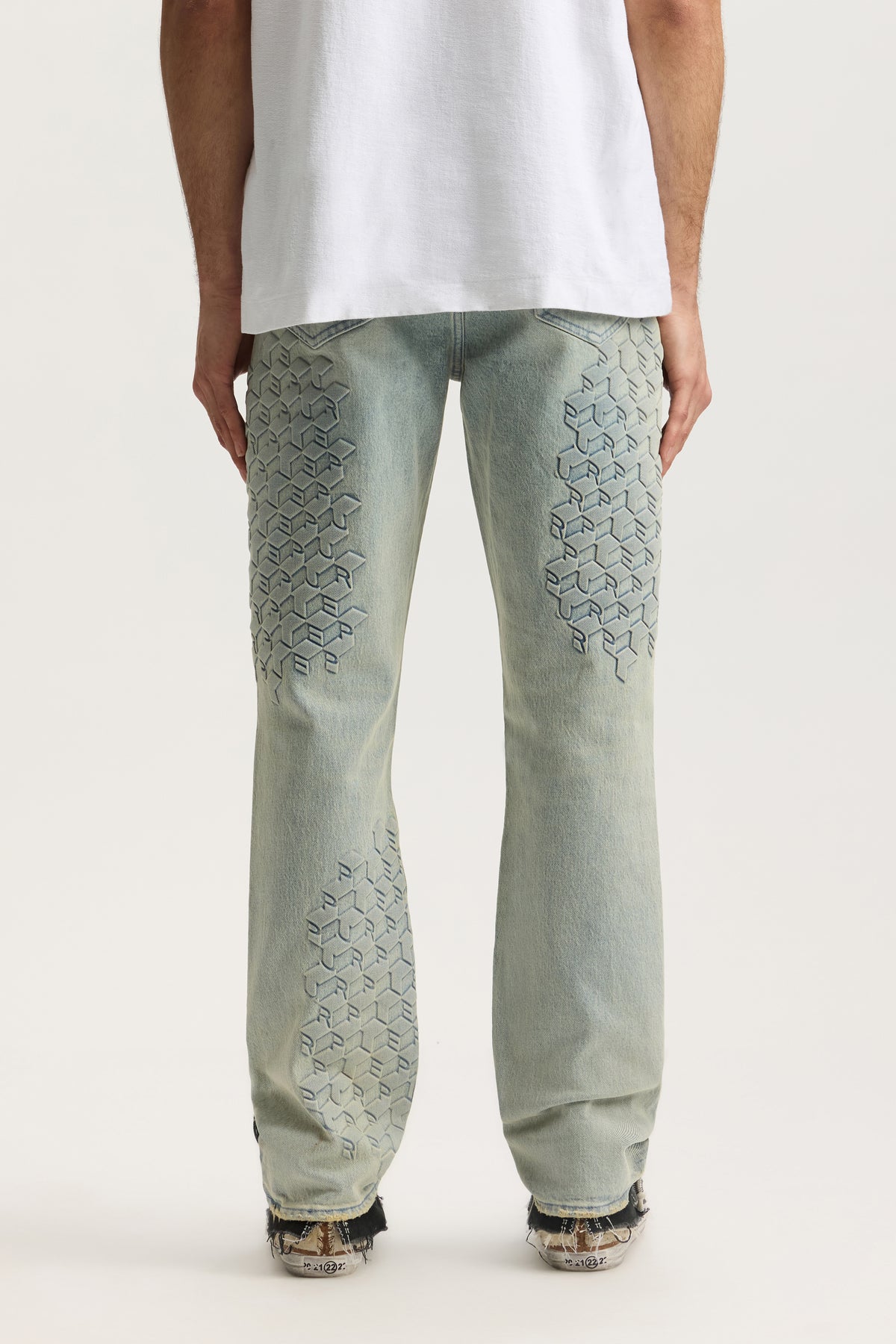 P005 Monogram Embossed denim, mid rise slim straight fit, sizes 28 to 42, unique embossed pattern.