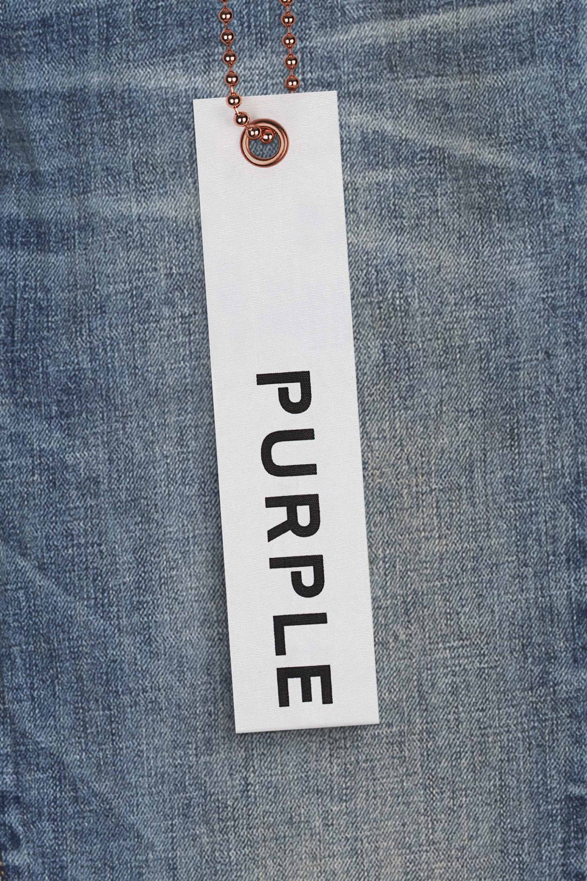 One Year Denim mid-rise slim leg jeans in medium indigo wash with whiskered and distressed details.