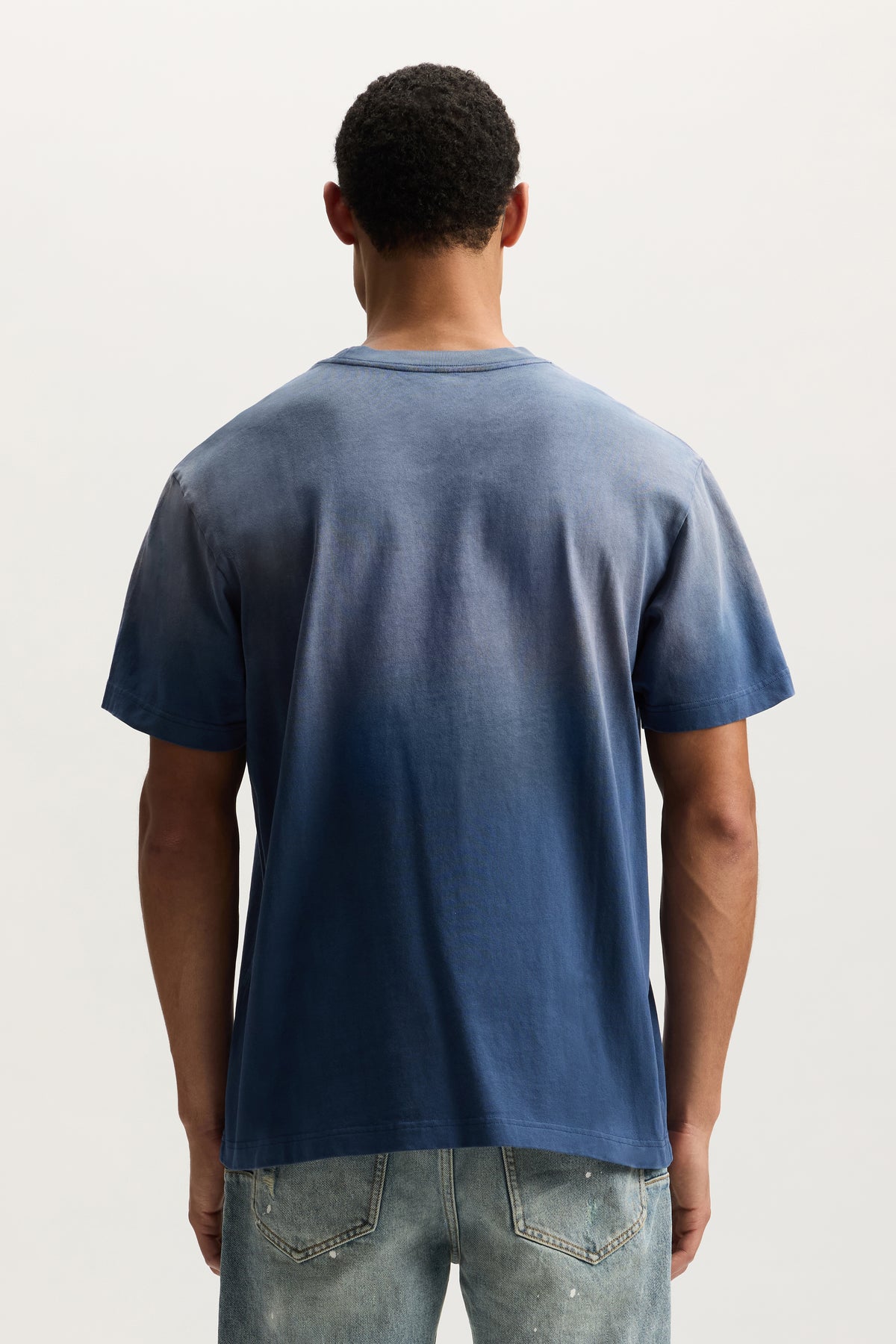 Slanted Script Tee in faded wash with crackle print, available in sizes XS to 3XL.