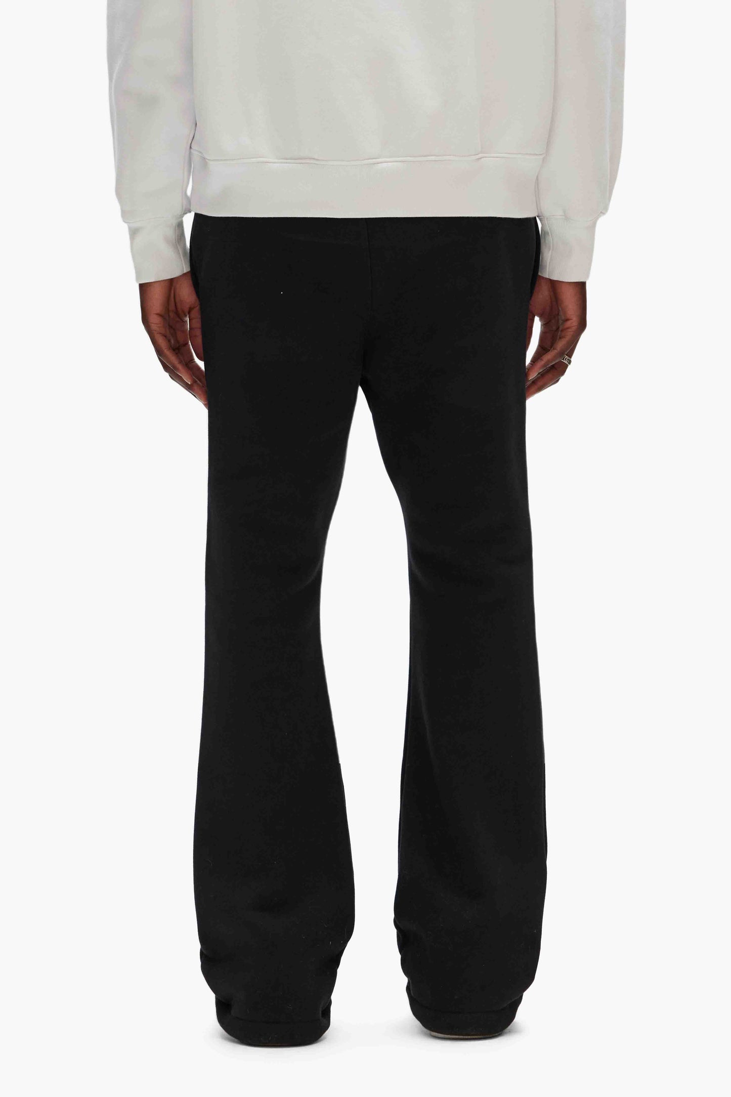Puff Sweatpants in heavyweight black fleece with flared silhouette and Purple Brand logo.