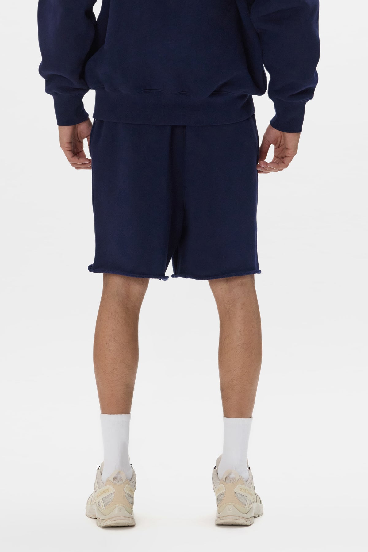 Basic Sweatshort in navy with relaxed fit and raw hem detail. Available in various sizes.