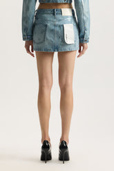 Monogram Mini Skirt in faded monogram design with low rise, front zipper, and 5 pocket styling.