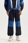 Wordmark Track Pant with TPU Wordmark, Relaxed Fit, Zipper Hand Pocket, Navy Color.
