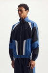 Wordmark Track Jacket in navy with TPU Wordmark and relaxed fit, featuring zipper pockets.