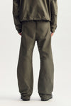 Embossed Tech Pant in green, relaxed fit, water-repellent woven polyester, featuring zipper pockets.