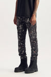 Denim P005 Marble, size 32, mid rise slim straight with bleach stains and paint splatters.